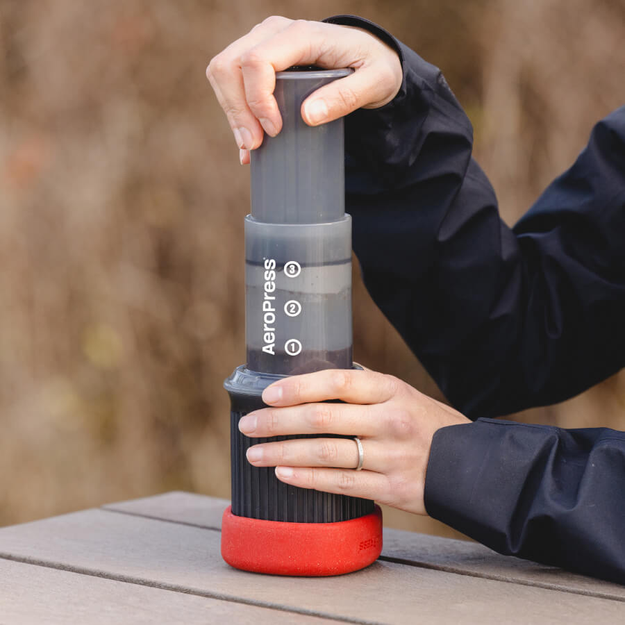 A barista making coffee with aeropress go on a table