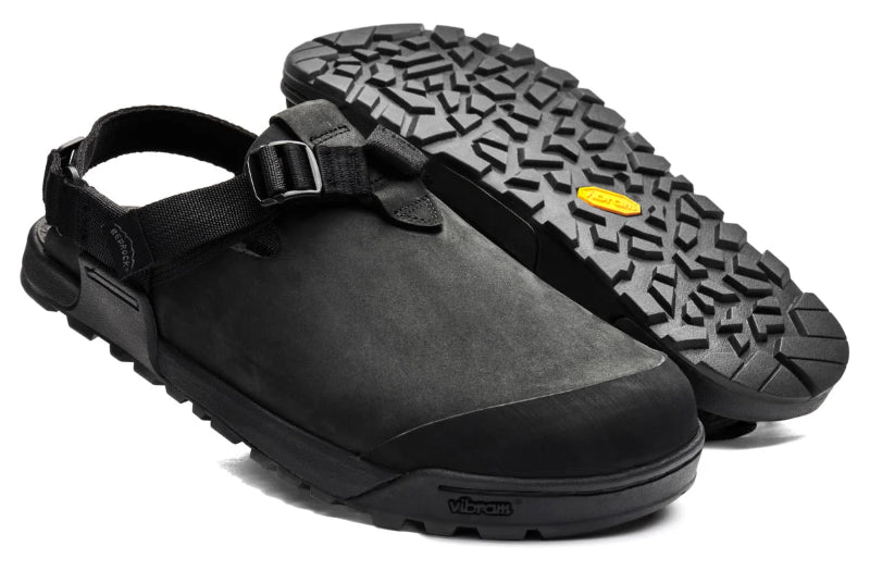 Black clog shoes with a textured sole on a white background