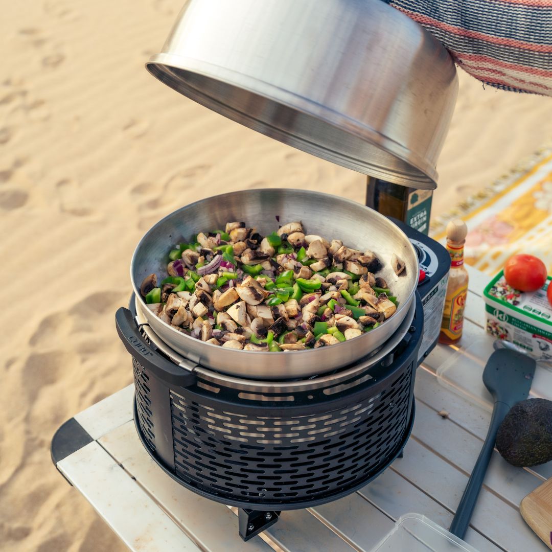 Cobb Grill black cooking with wok at the beach