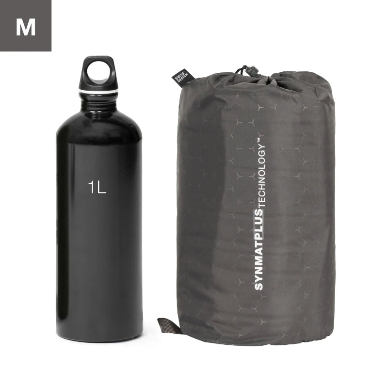 Black water bottle labeled '1L' next to a gray compression sack with 'SYMPHONY PLUS TECHNOLOGY' branding on a white background.