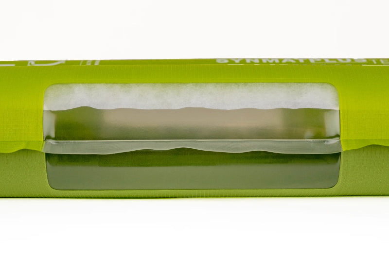Green package with a clear window showing a beige product inside on a white background