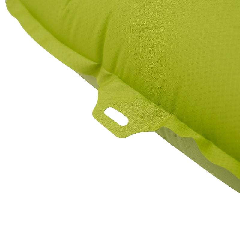 Close-up of a green fabric with a white button on a white background