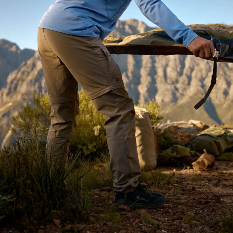Person hiking with backpacks in a mountainous landscape