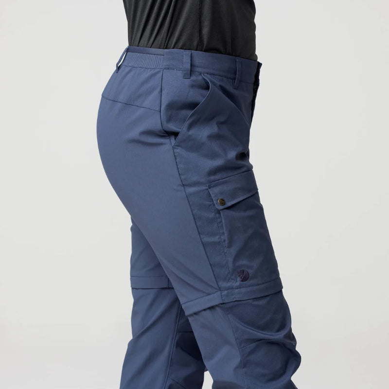 Blue cargo pants on a gray background