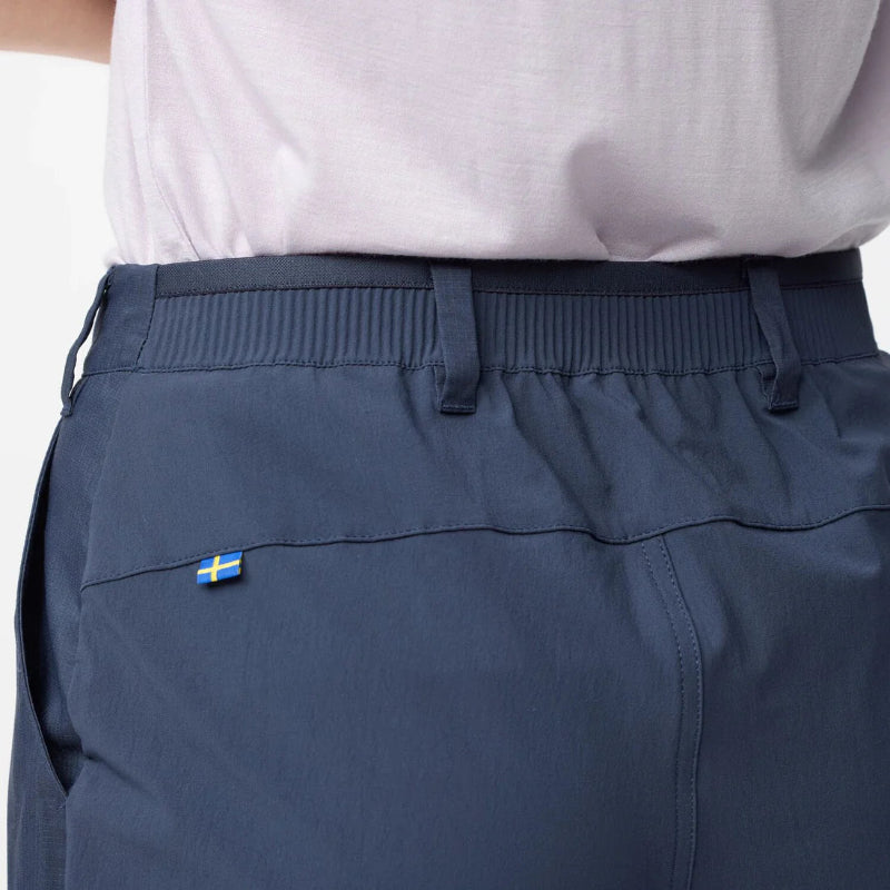 Navy pants with a small flag patch on the pocket, worn by a person.