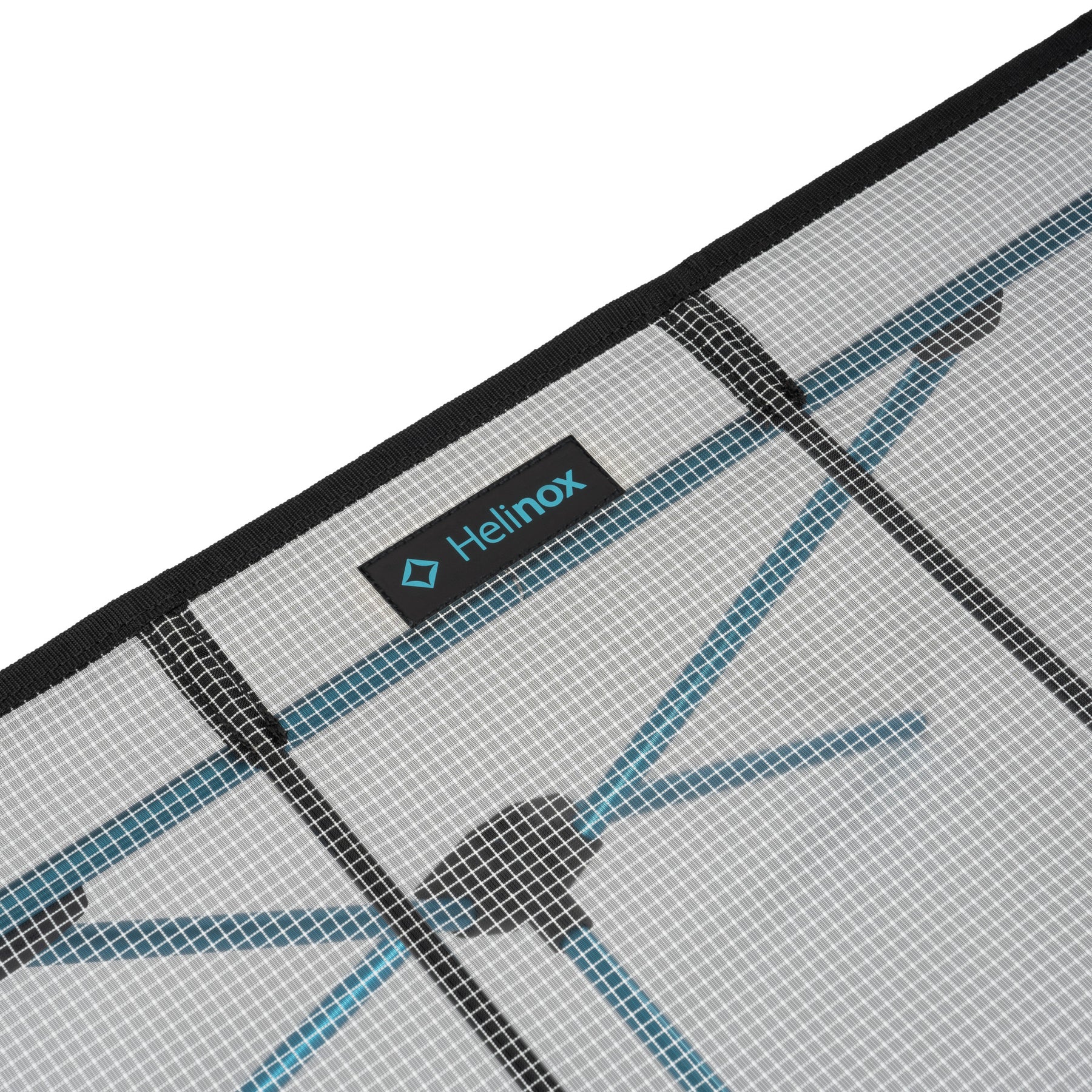 Close-up of ultralight Helinox Camping Table setup on a white background