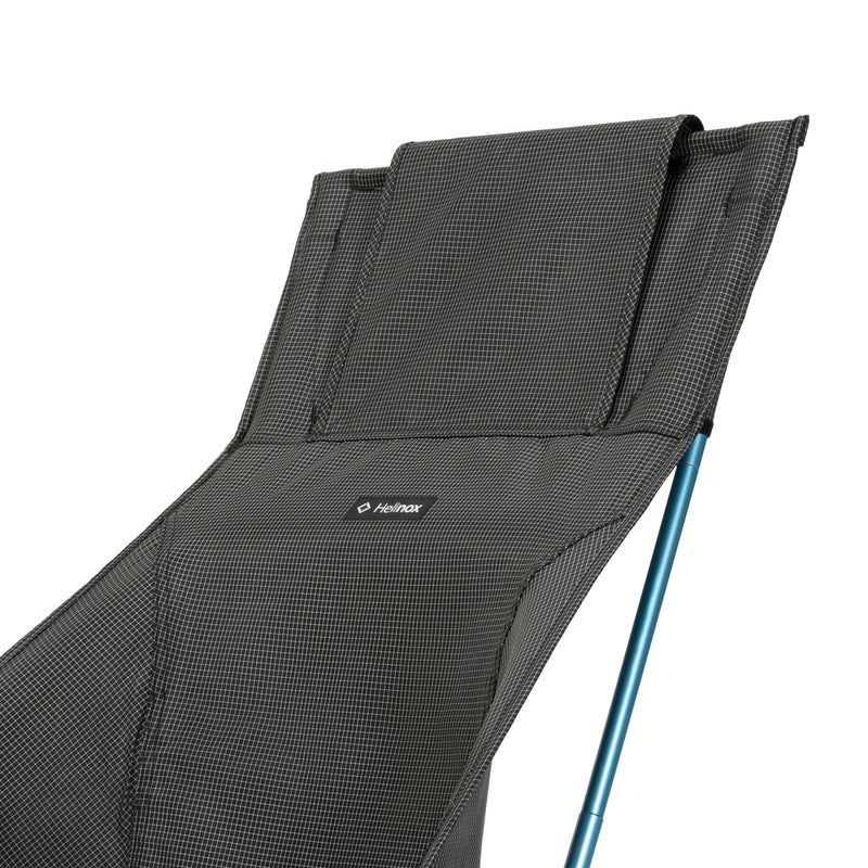 Black camping chair with mesh backrest and blue leg on a white background