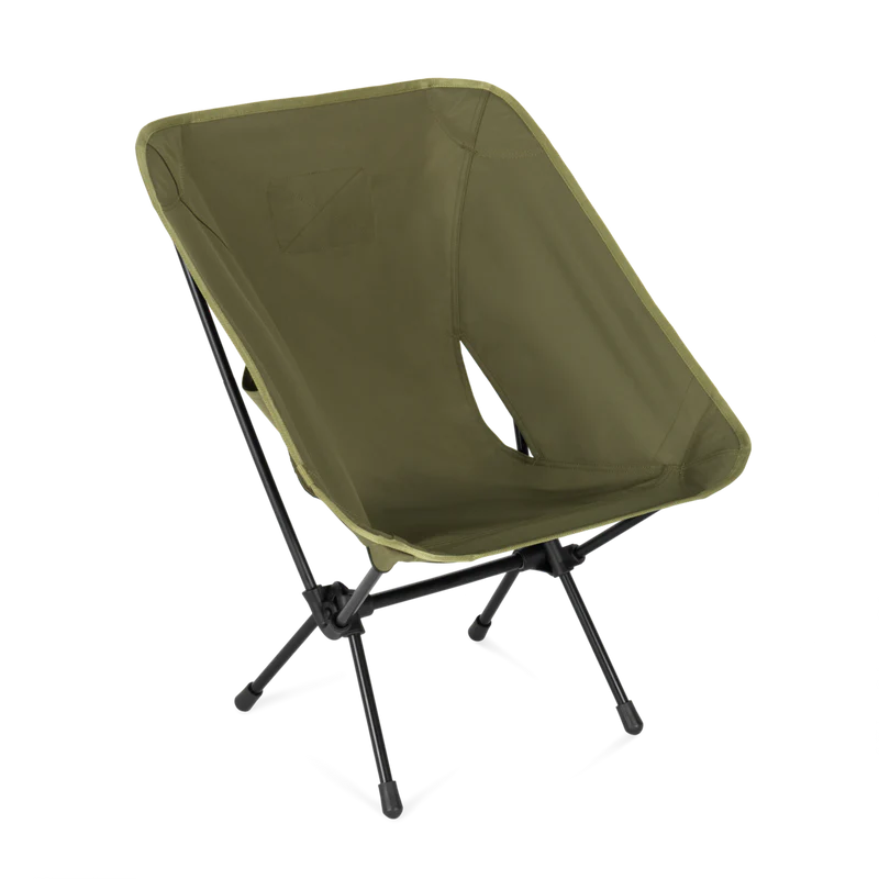 Green camping chair with black legs on a white background