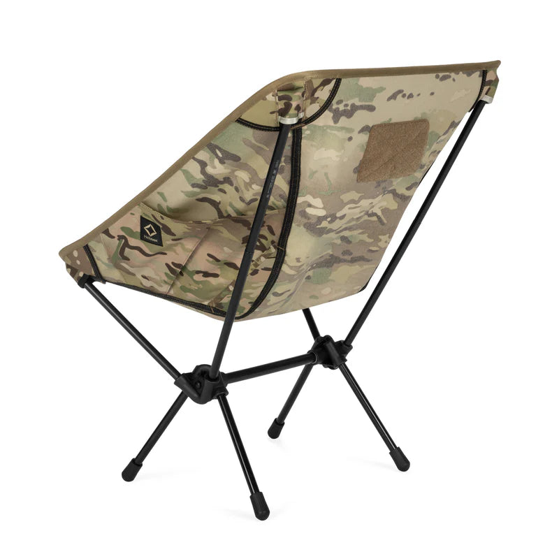 Camouflage folding chair with black legs on a white background