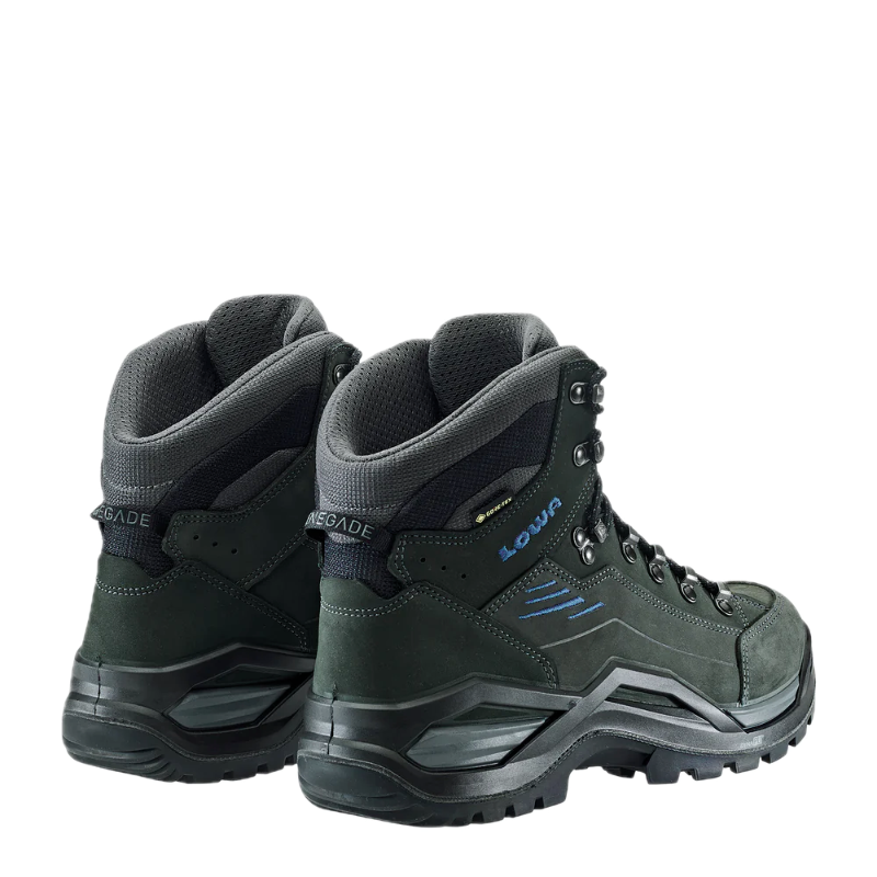 Pair of green hiking boots with black soles on a white background