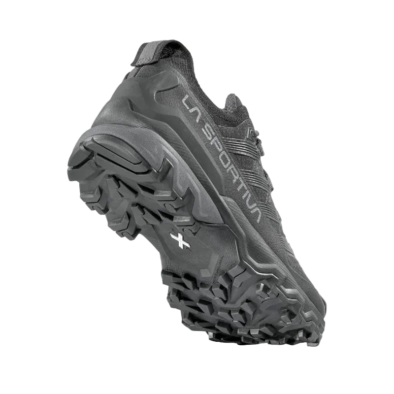 Black hiking shoe with brand logo on a light gray background