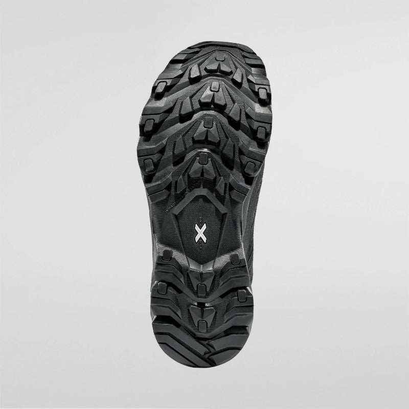 Close-up of a black hiking boot sole on a light gray background