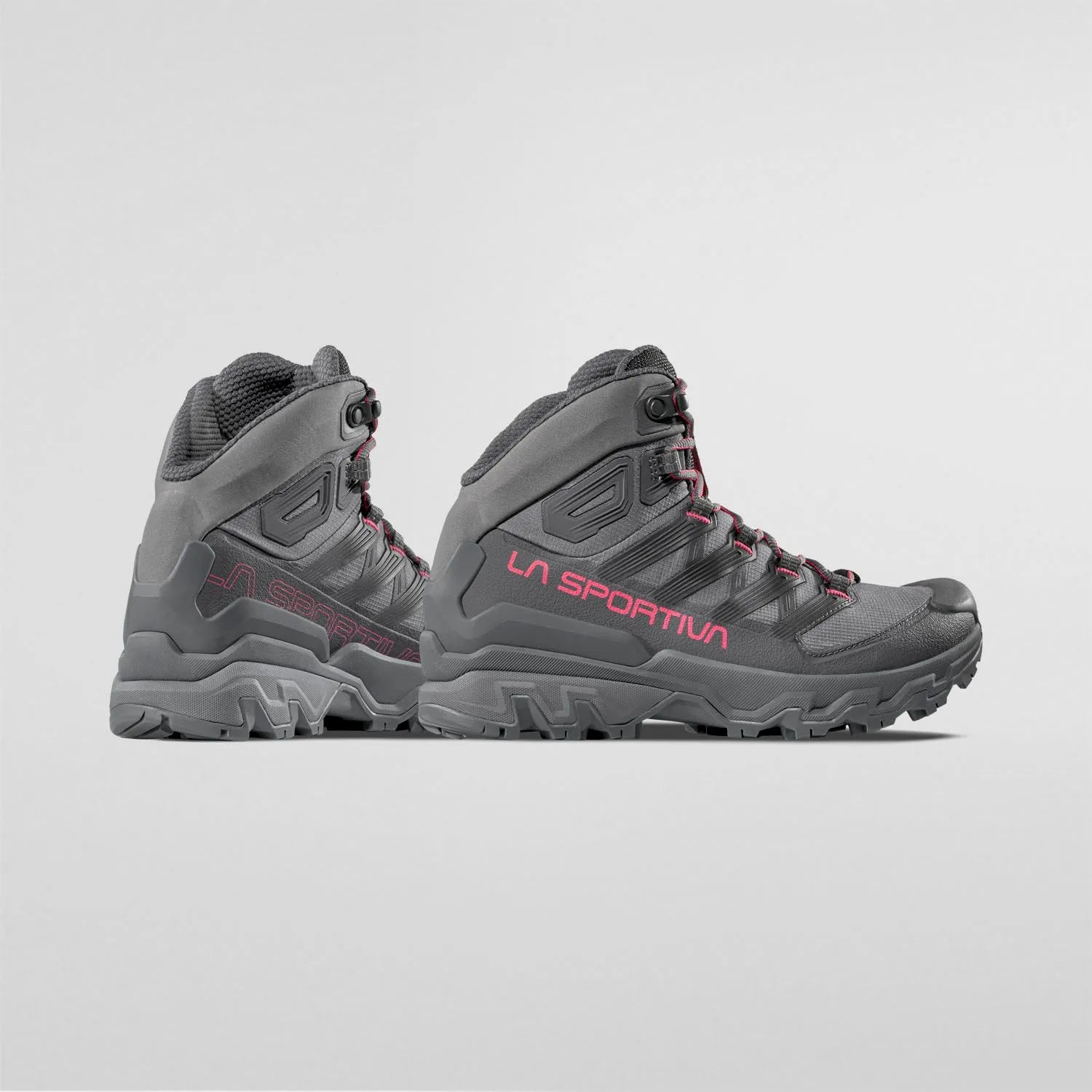 Gray La Sportiva hiking boots with red accents on a light gray background