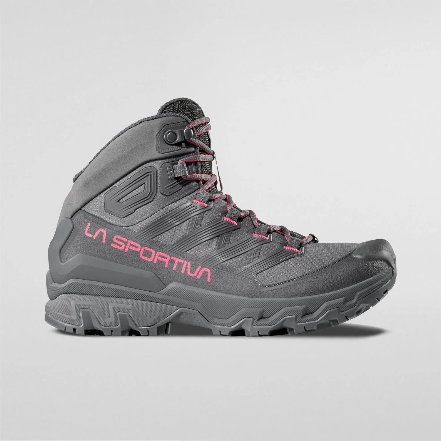 Gray La Sportiva waterproof Womens hiking boots with pink branding on a light gray background