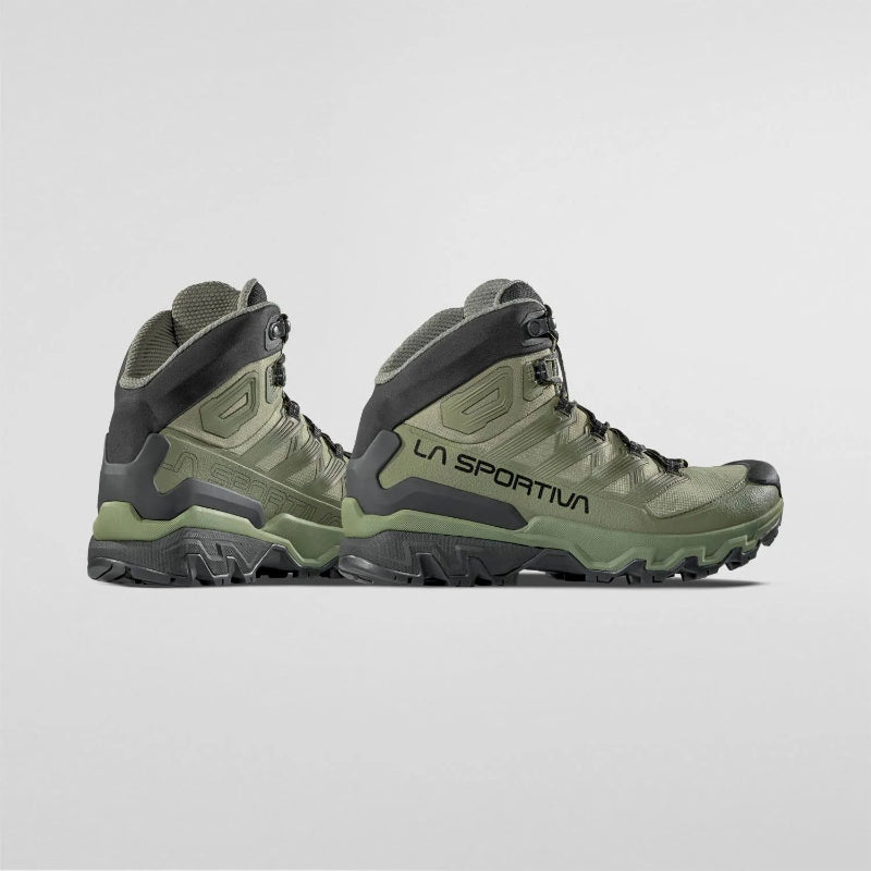 Green hiking boots with black accents on a light gray background