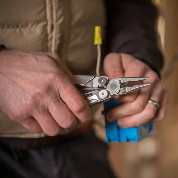 Multitool in hands with a blurred background