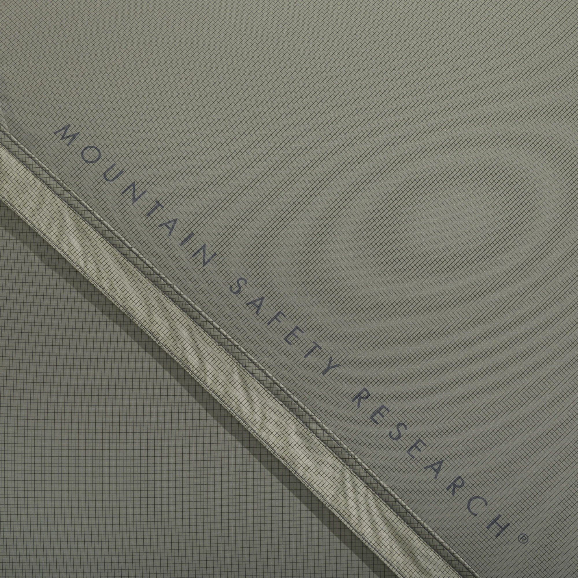 Close-up of a product with 'Mountain Safety Research' branding on a gray background