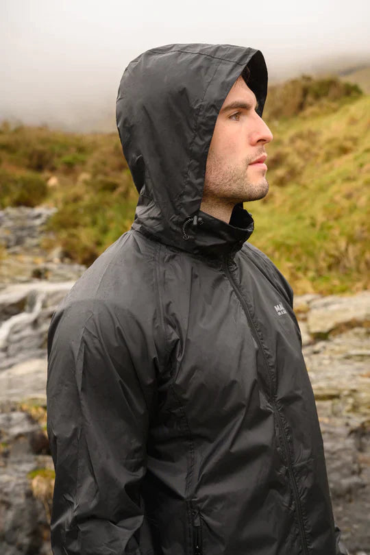 Man wearing the black mac in a sac origin 2 rain jacket with the hood on