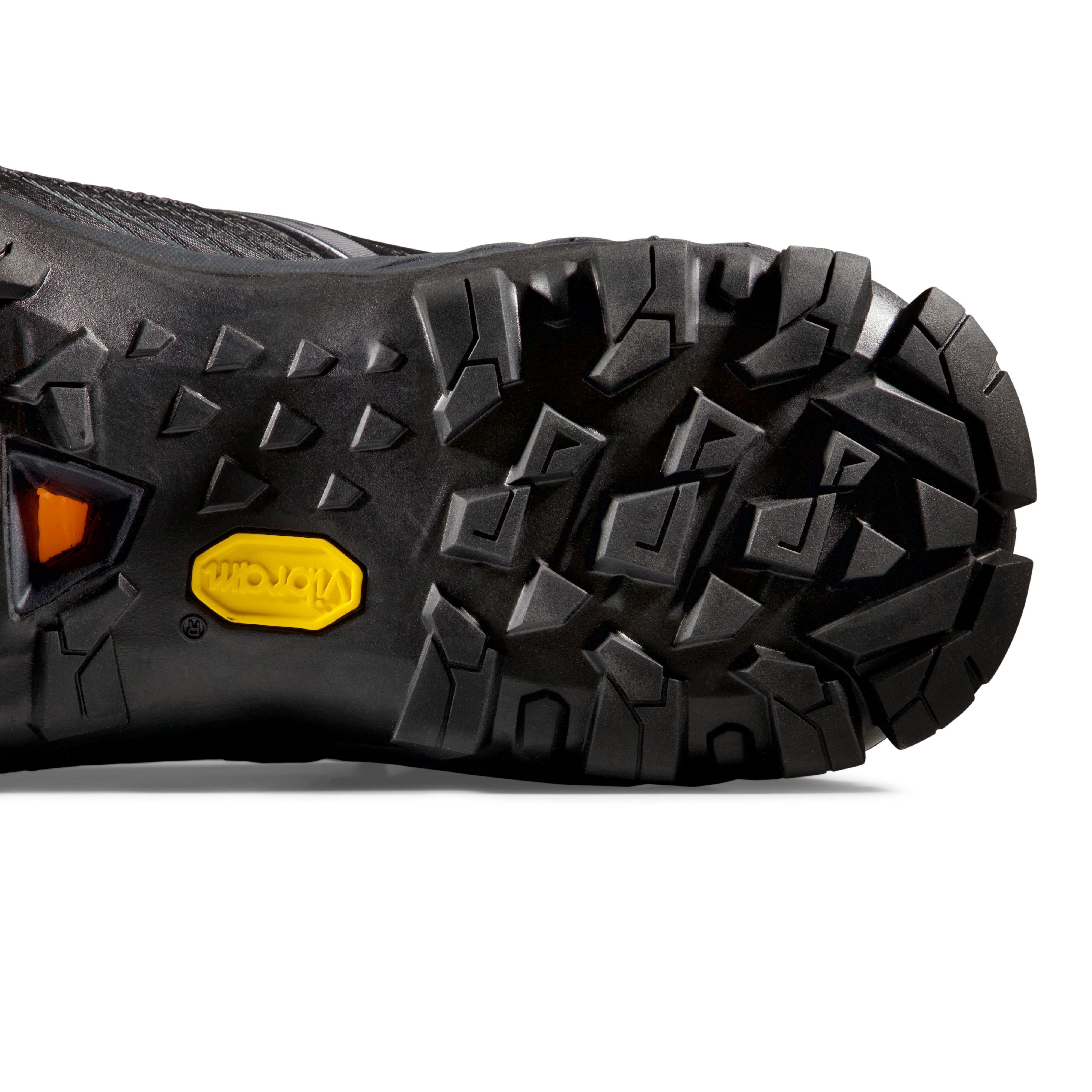 Close-up of a black hiking boot sole with a brand logo on a white background