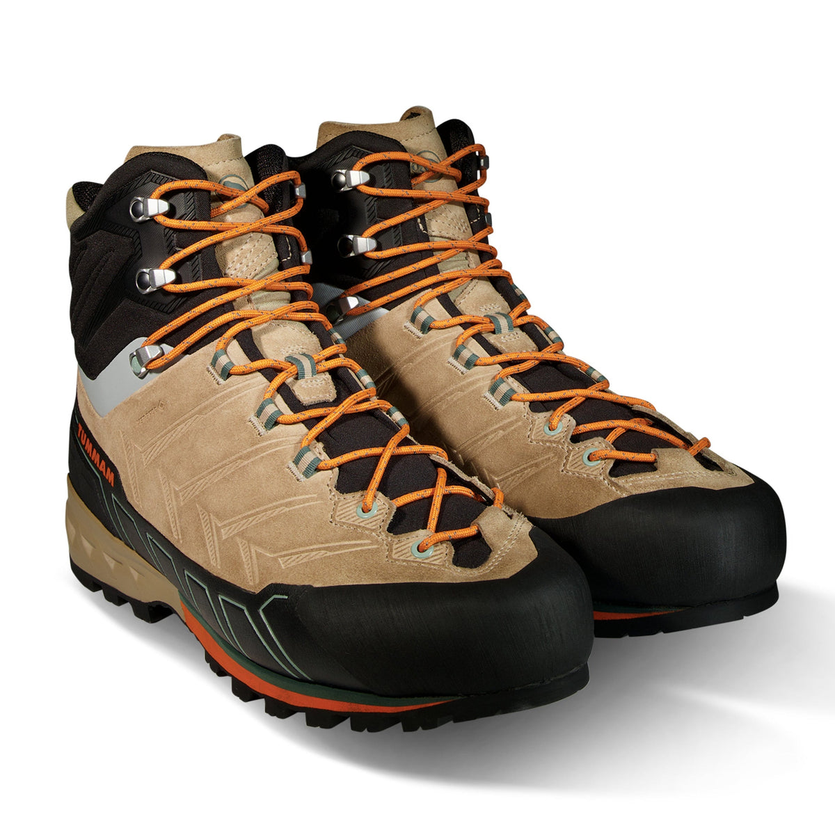 Pair of beige and black hiking boots with orange laces on a white background