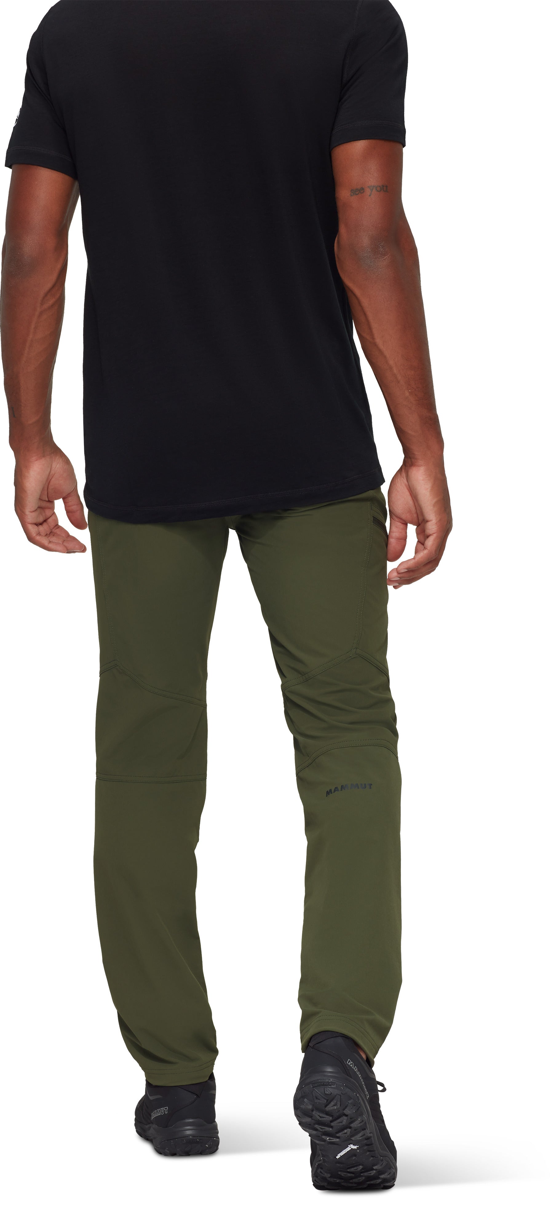Person wearing a black t-shirt and green pants on a white background