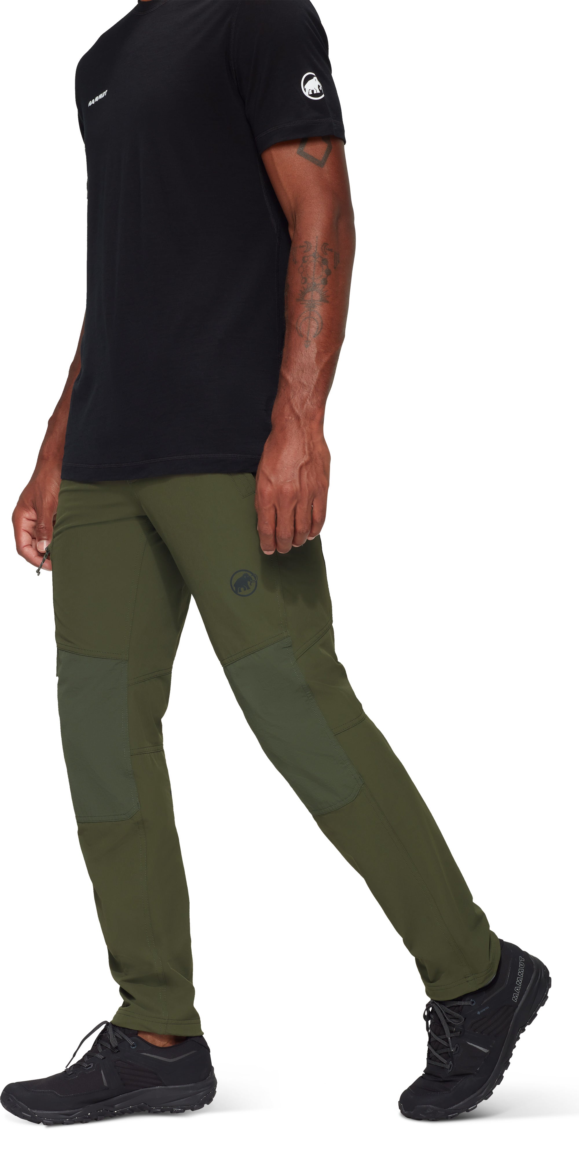 Person wearing a black t-shirt, green pants, and black shoes on a white background