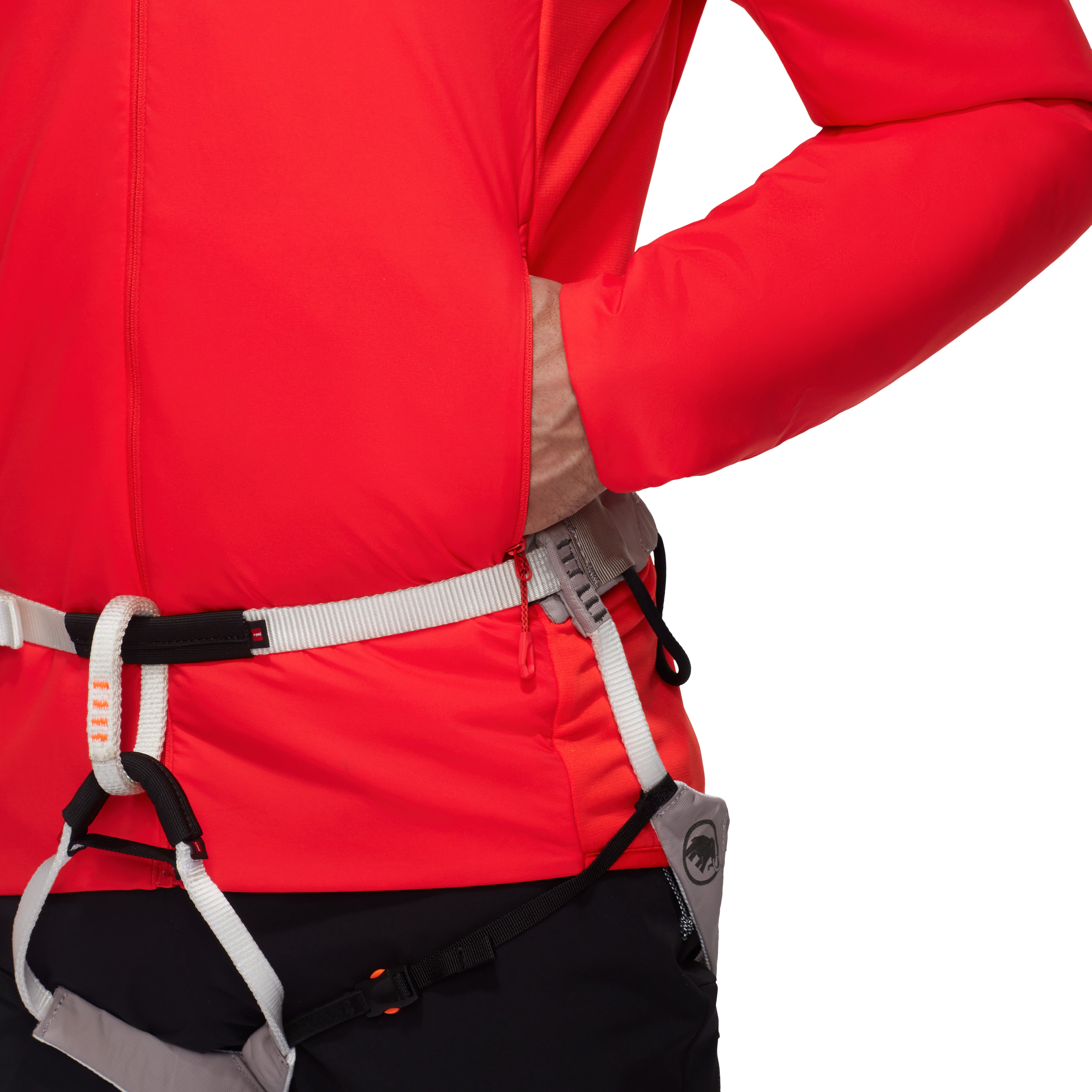 Person wearing a red jacket with climbing harnesses on a white background
