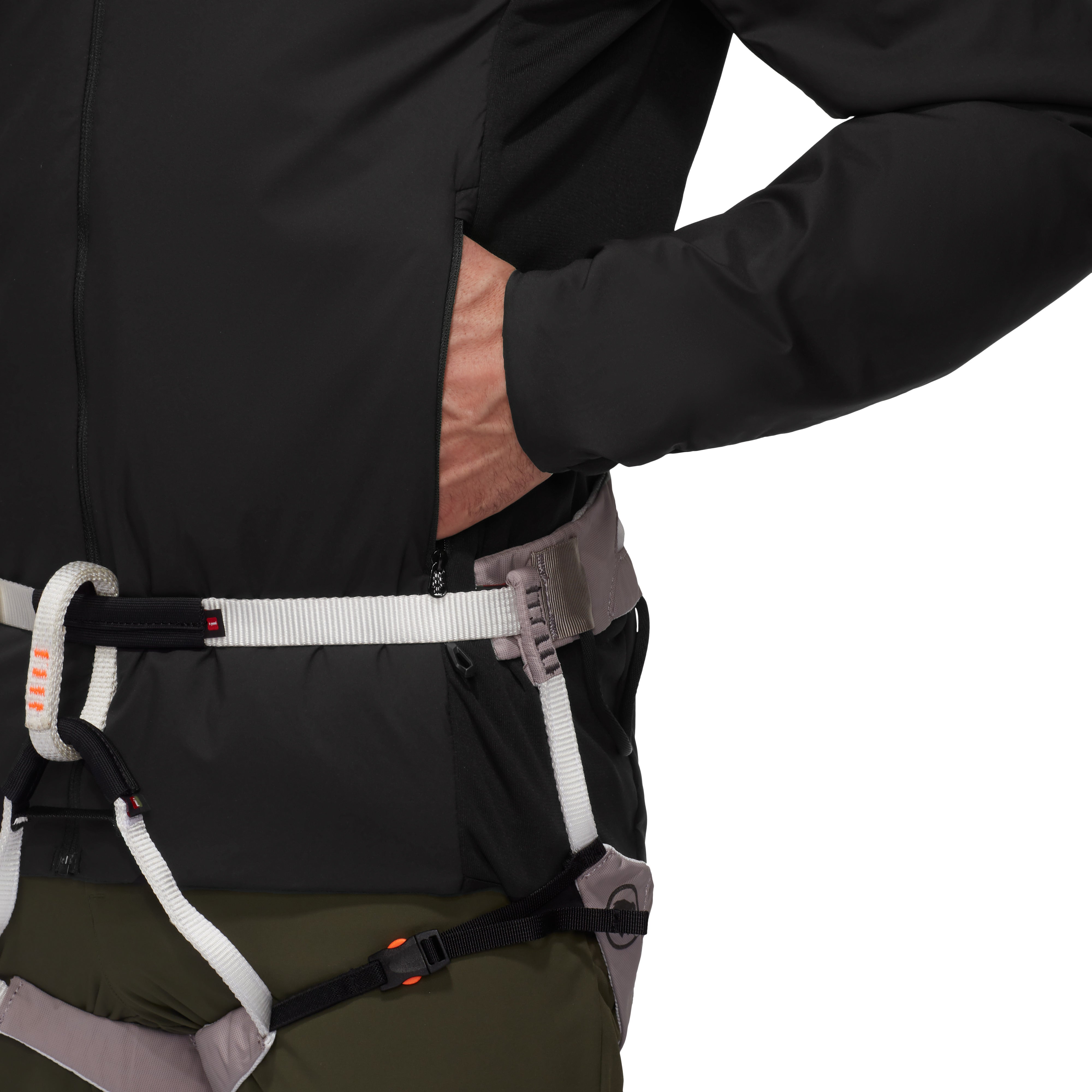 Close-up of a person wearing a black jacket with a climbing harness