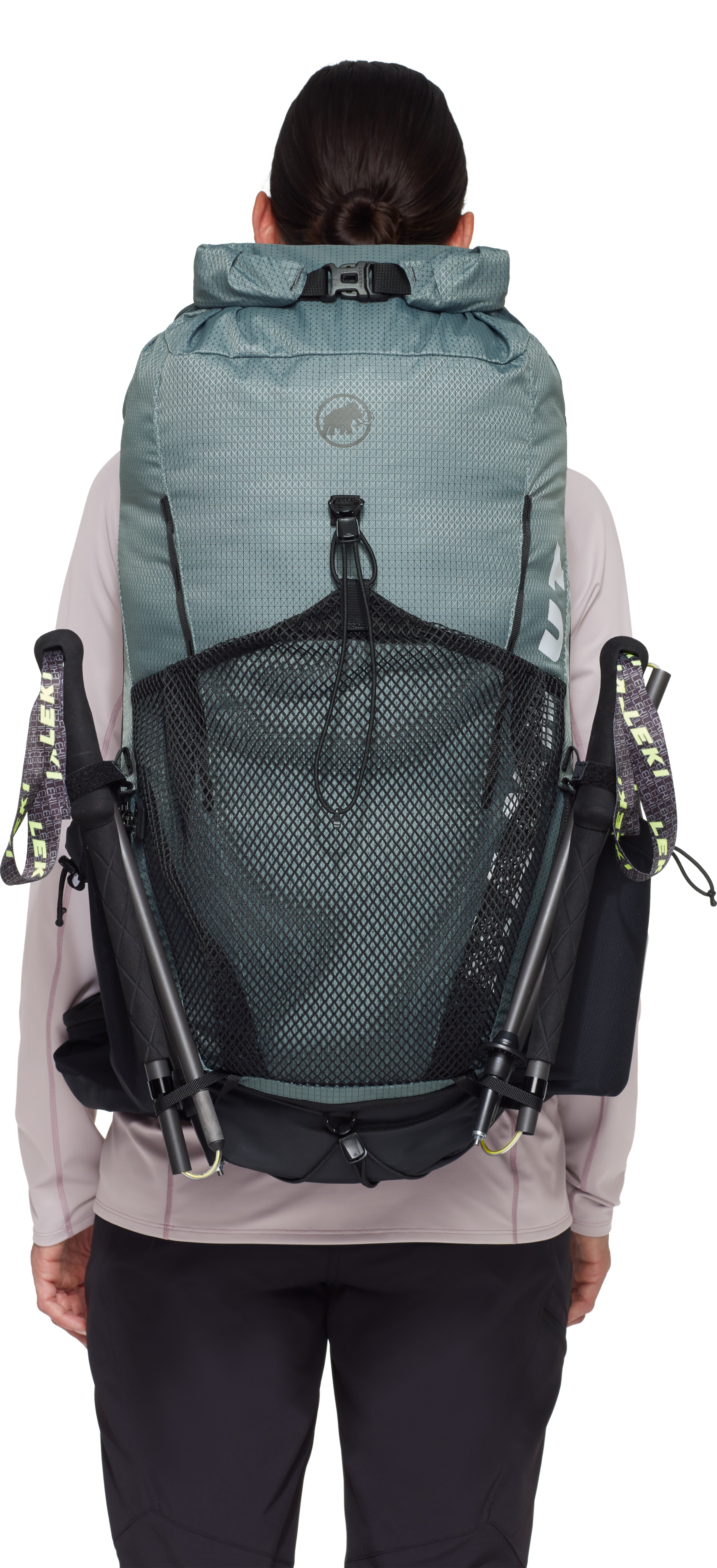 Person wearing a blue backpack with multiple straps on a white background