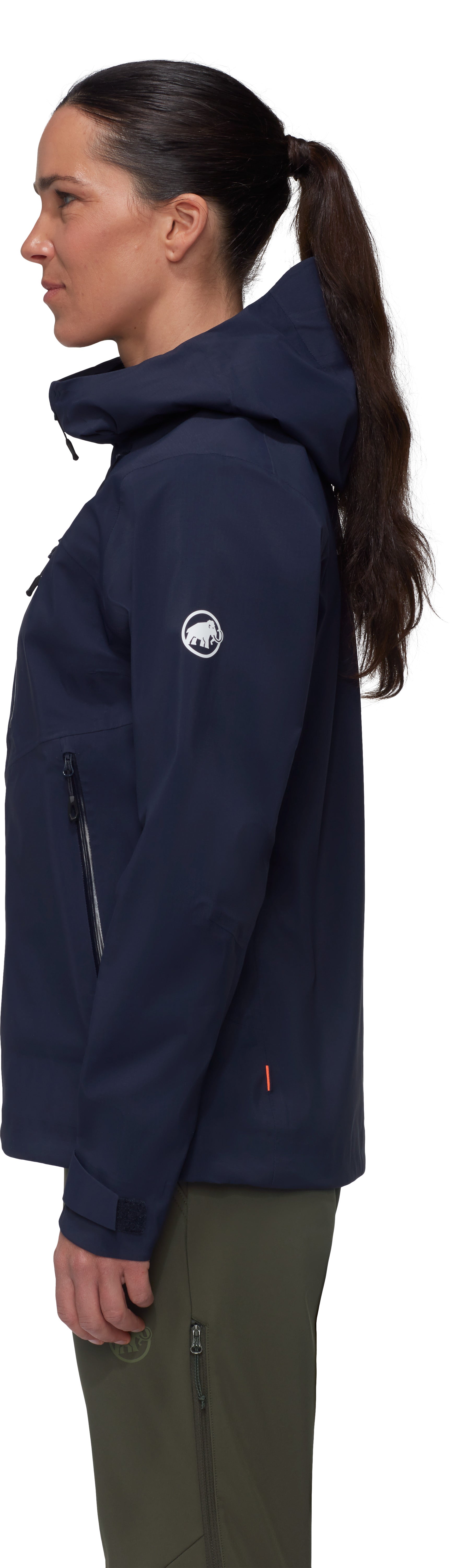 Person wearing a navy blue jacket with a logo on the chest, standing against a white background.