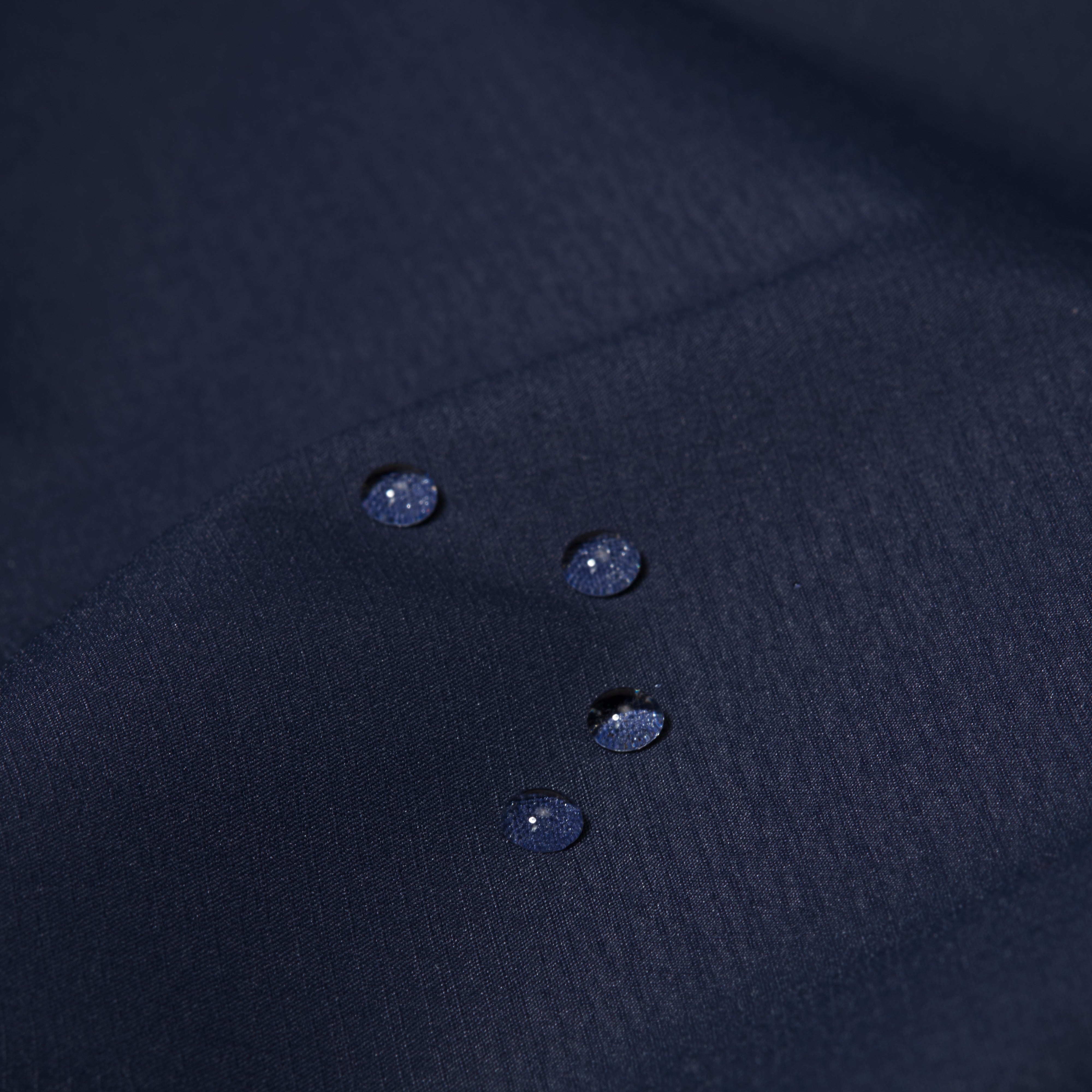 Close-up of a dark blue fabric with rain drops
