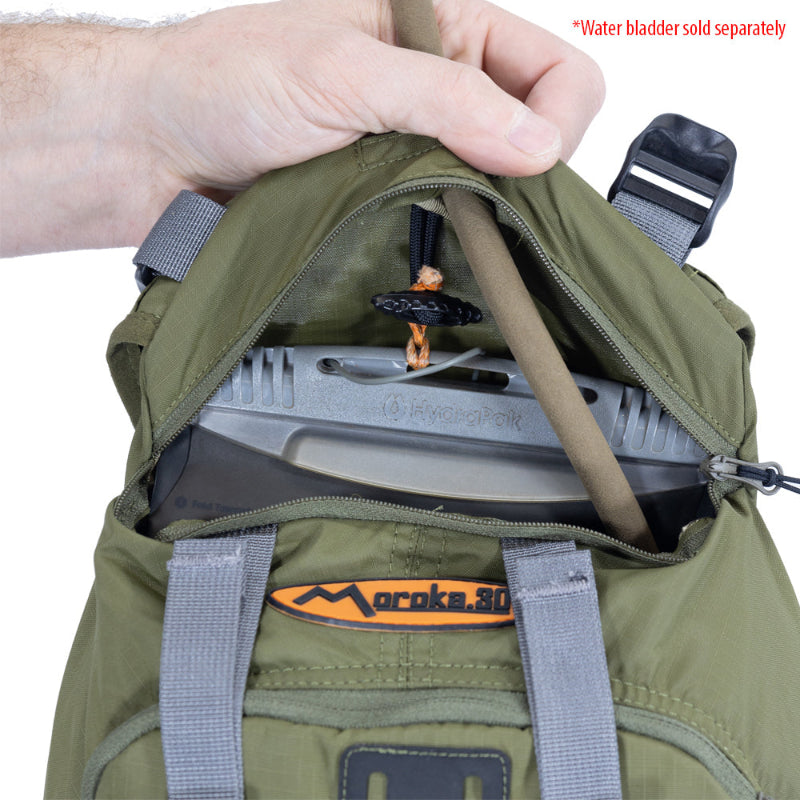 Green backpack with a water bladder holder, showing the brand 'Moroka'.