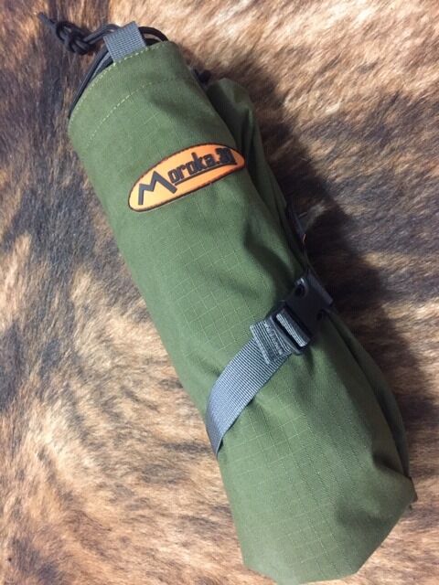 Green roll-up bag with a logo on a brown fur background