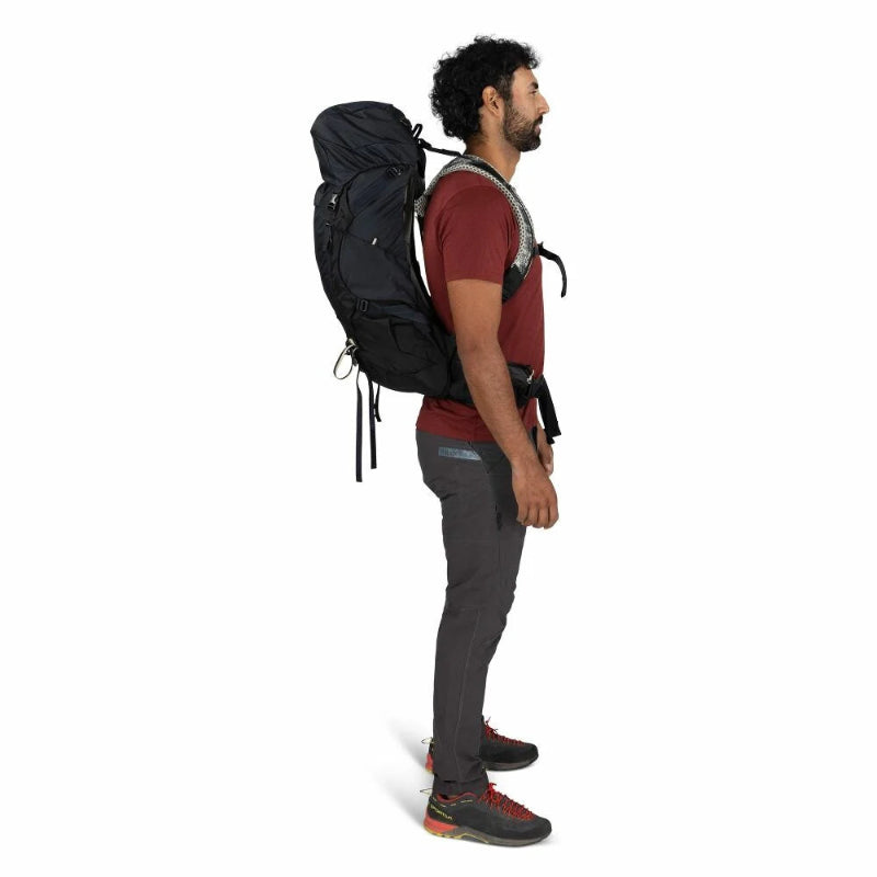 Man wearing a black hiking backpack on a white background