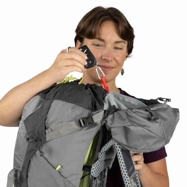 Person adjusting a backpack with a white background