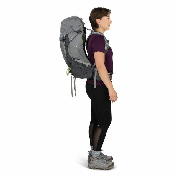 Person wearing a gray hiking backpack on a white background