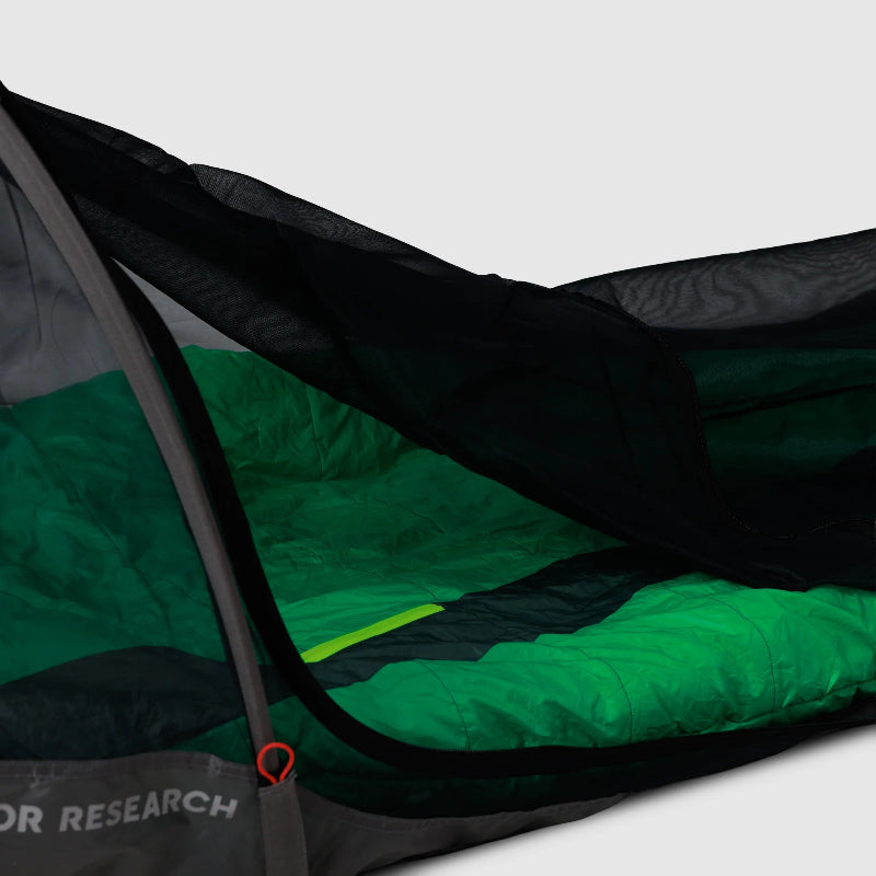 Green and black sleeping bag with Outdoor Research bug net bivy