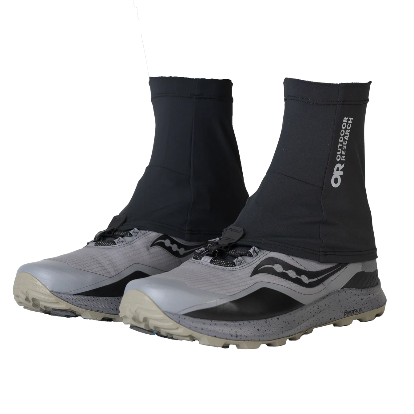 Black gaiters on gray hiking shoes with 'Outdoor Research' branding on a white background