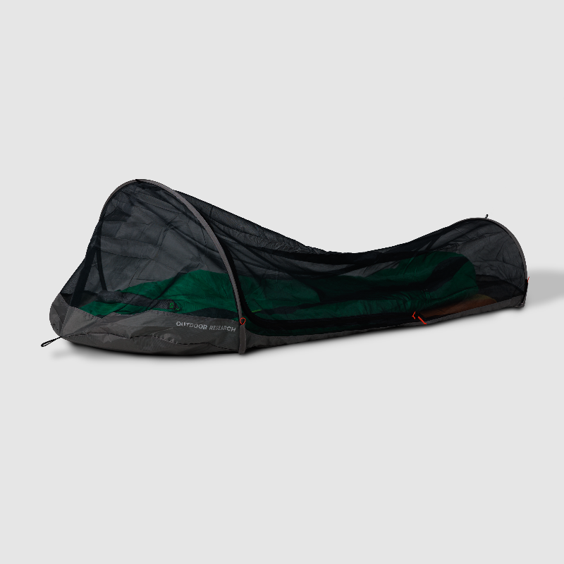Camping tent in a black carrying bag on a light gray background