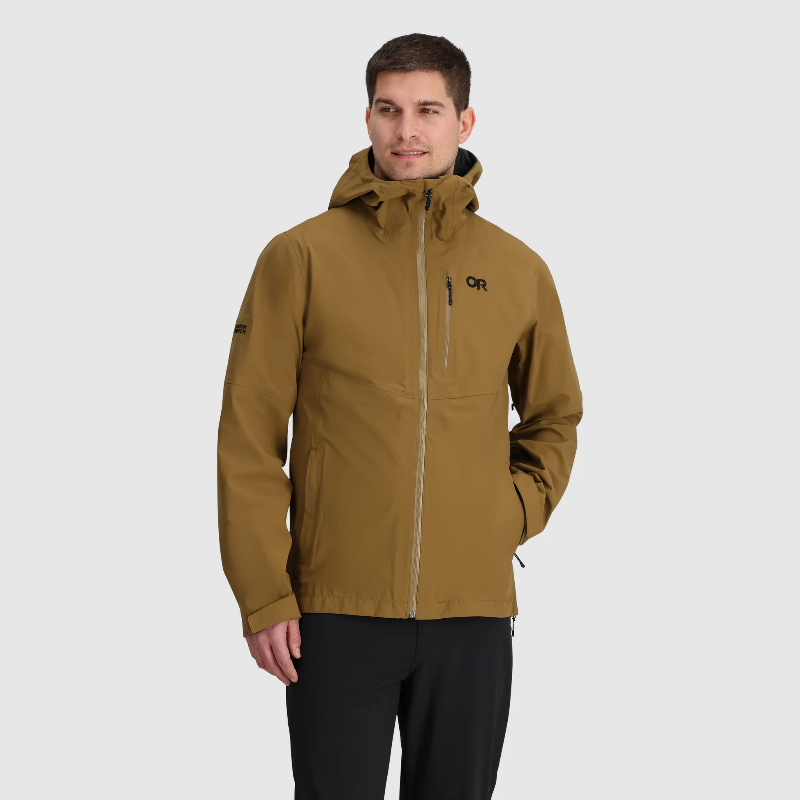 Man wearing a brown jacket with a hood on a gray background