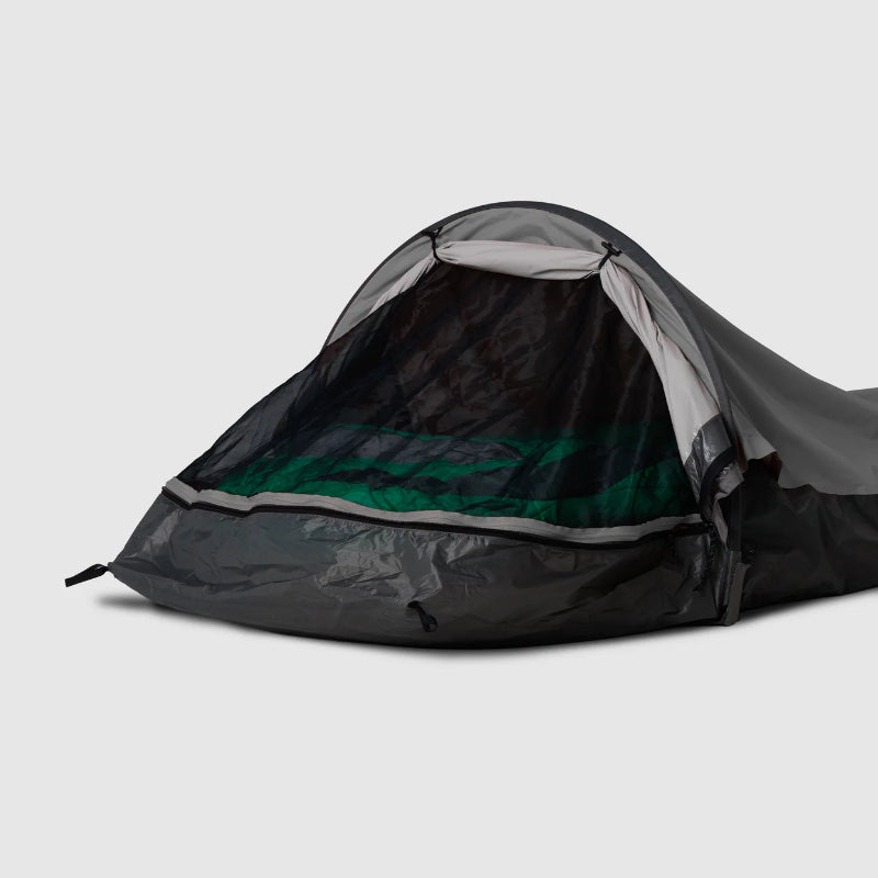 Black and green bivy on a light gray background