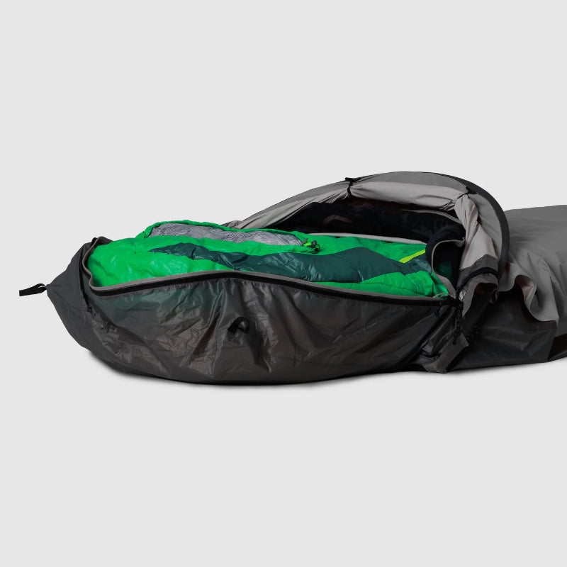 Gray and green sleeping bag in a light gray bivy