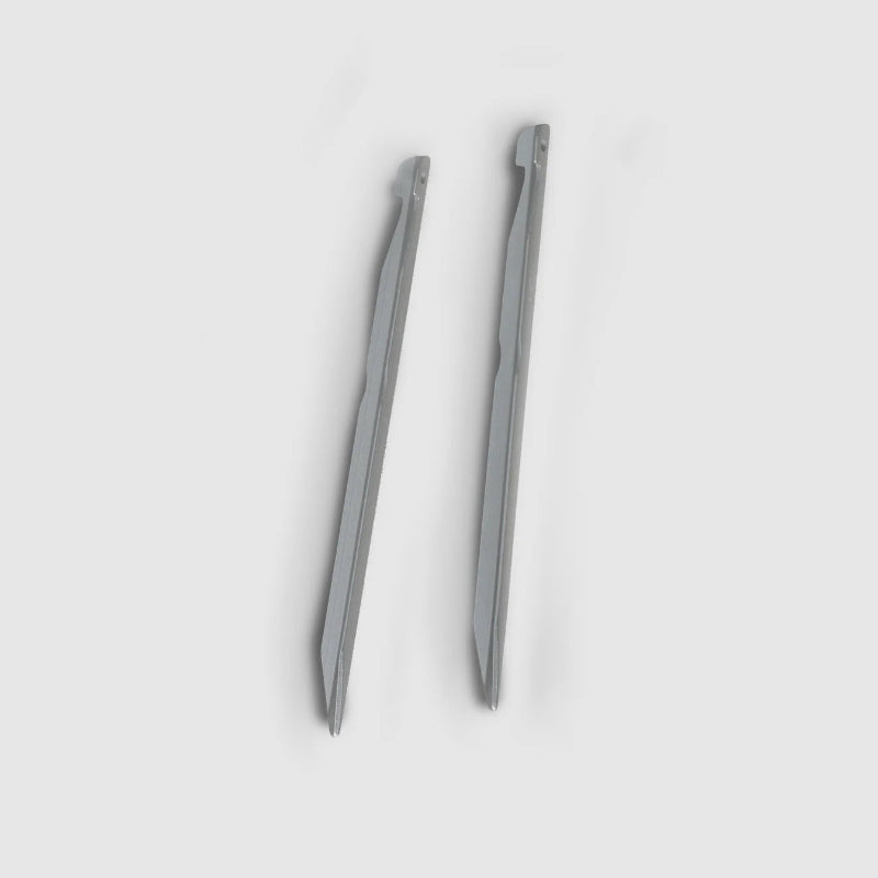 Two metallic stakes on a light gray background