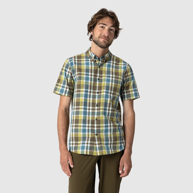 Man wearing a plaid shirt on a plain background
