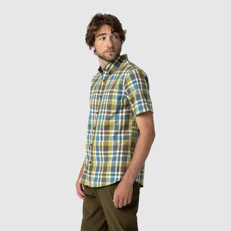 Man wearing a plaid shirt on a plain background