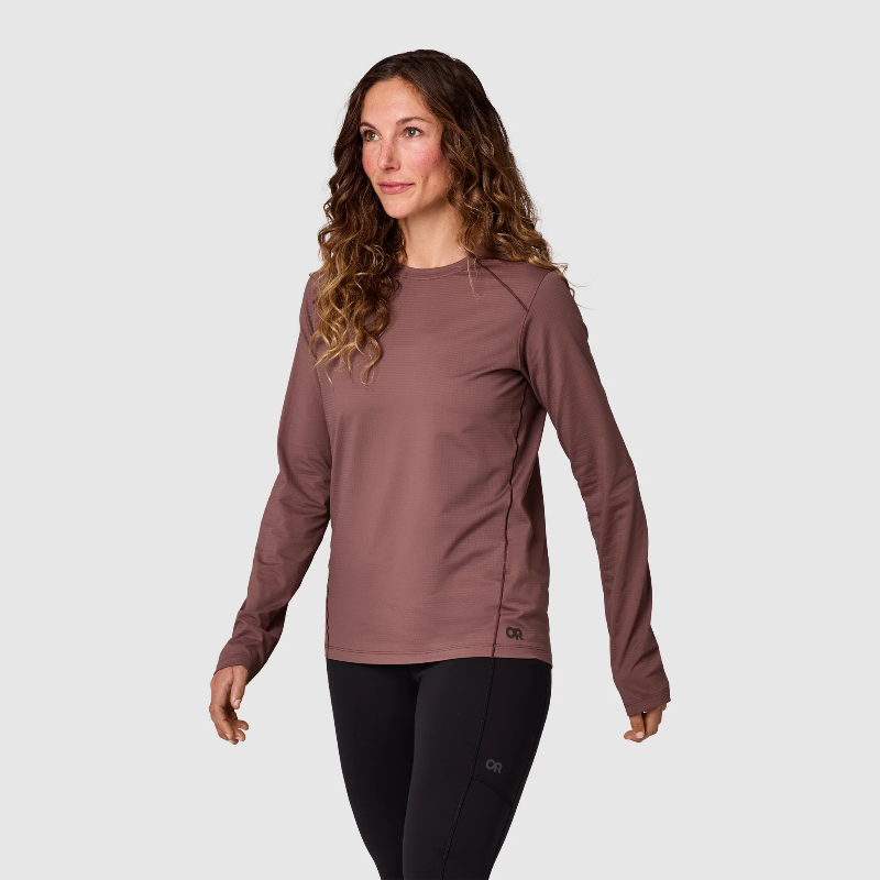 Woman wearing a brown long-sleeve top on a white background