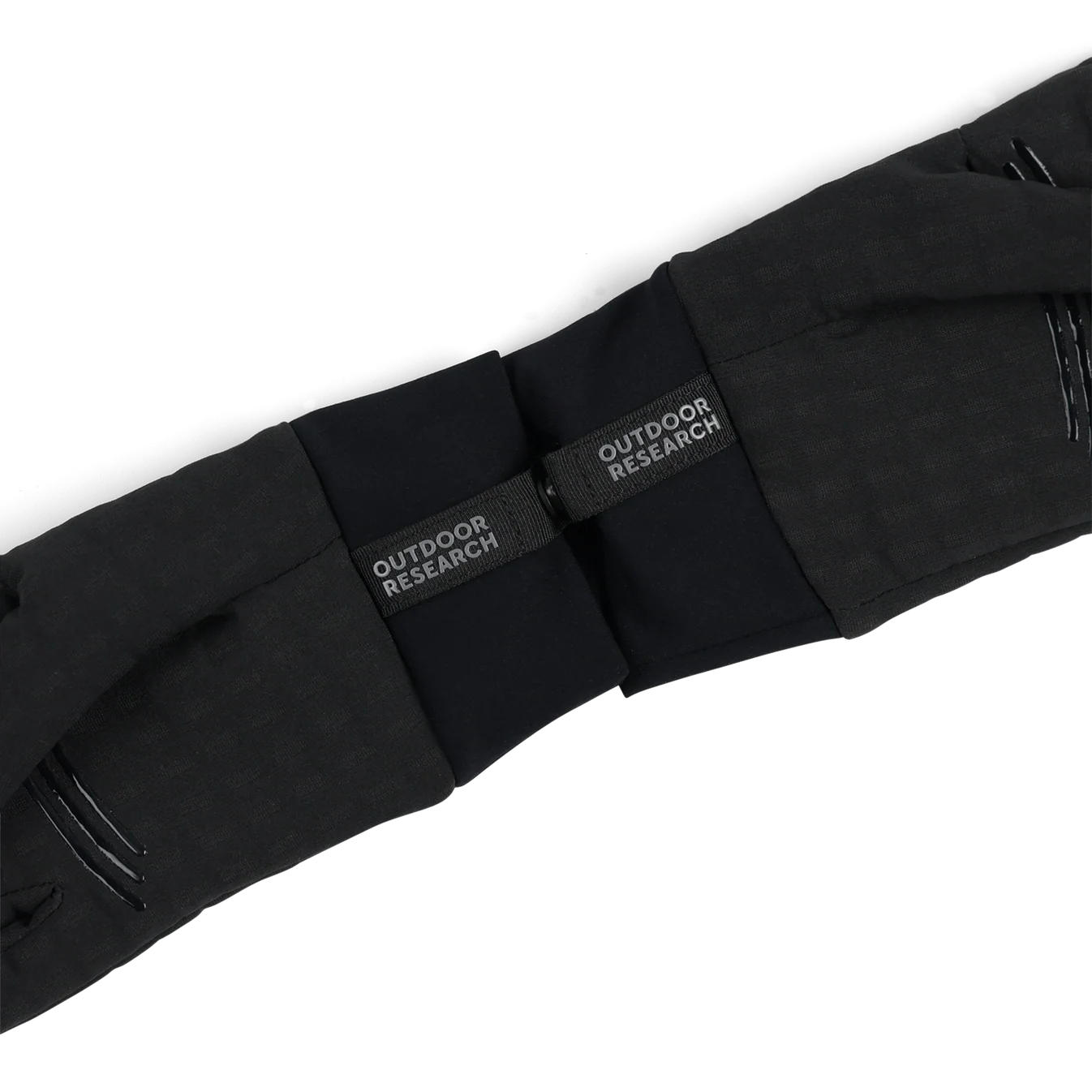 Close-up of black pants with Outdoor Research labels on a white background