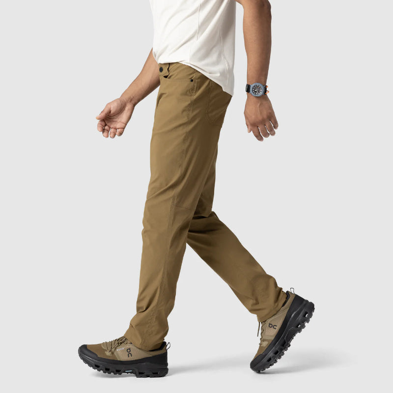 Person wearing brown pants and black shoes on a white background