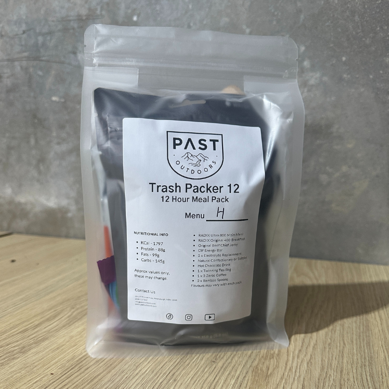 Packaged meal with 'PAST Outdoors' label on a wooden surface