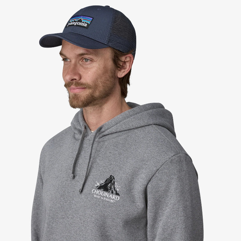 Man in a grey hoodie wearing the Patagona P-6 Logo LoPro Trucker Hat in New Navy